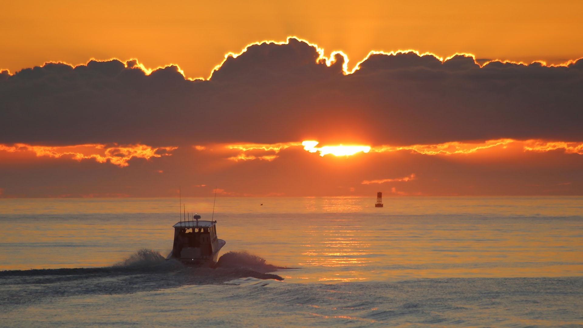 A boat heads out to the Atlantic Ocean as the sun rises at Port Canaveral.